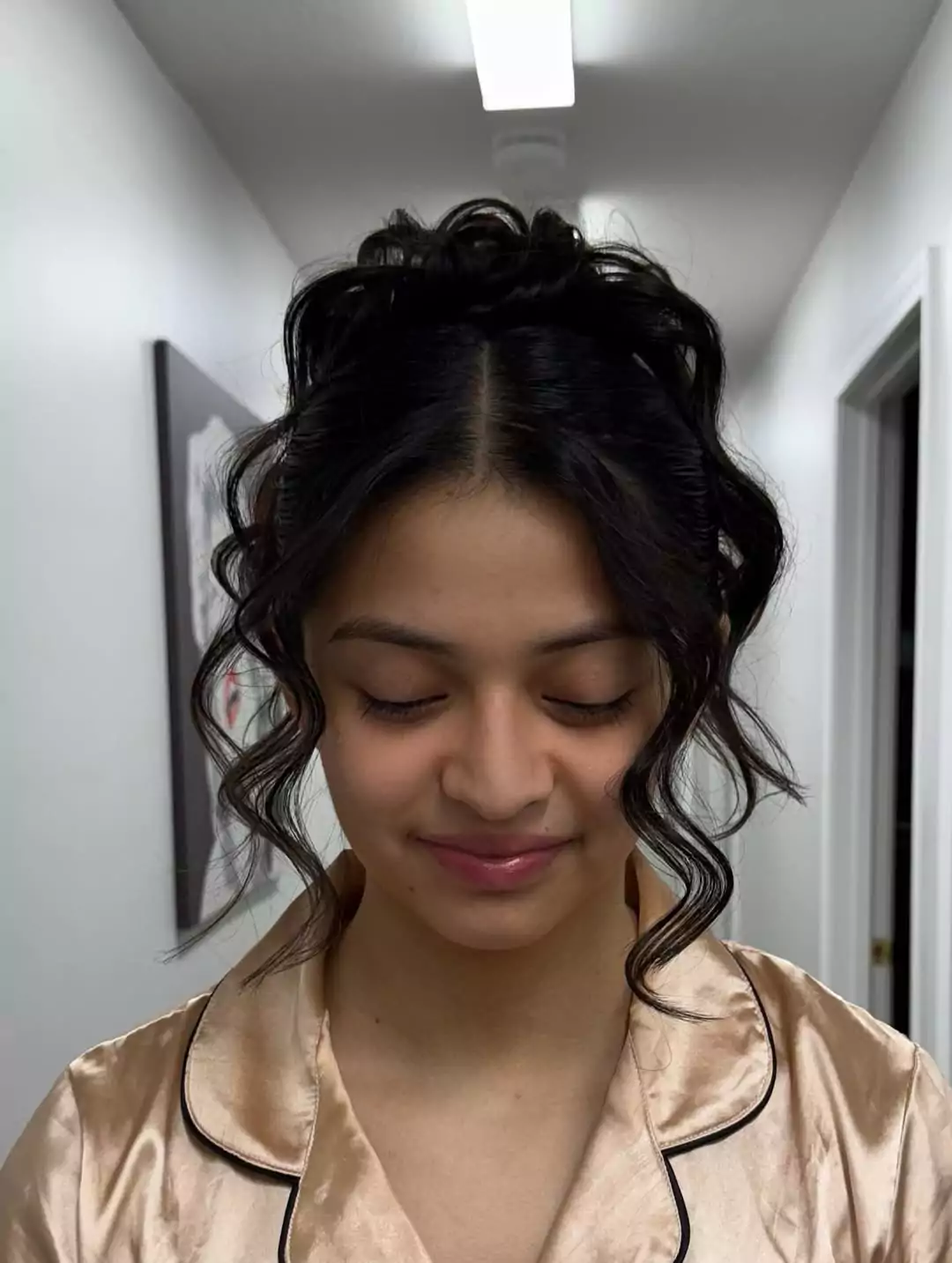 Messy Top Knot with Face-Framing Curls