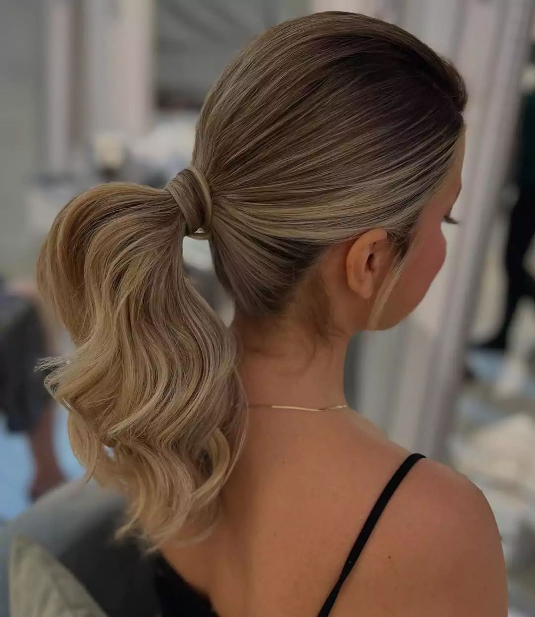 Sleek High Ponytail with Voluminous Curls