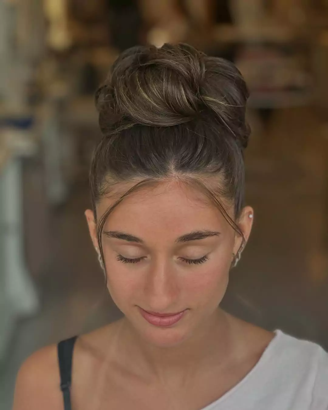 Textured High Bun with Face-Framing Wisps