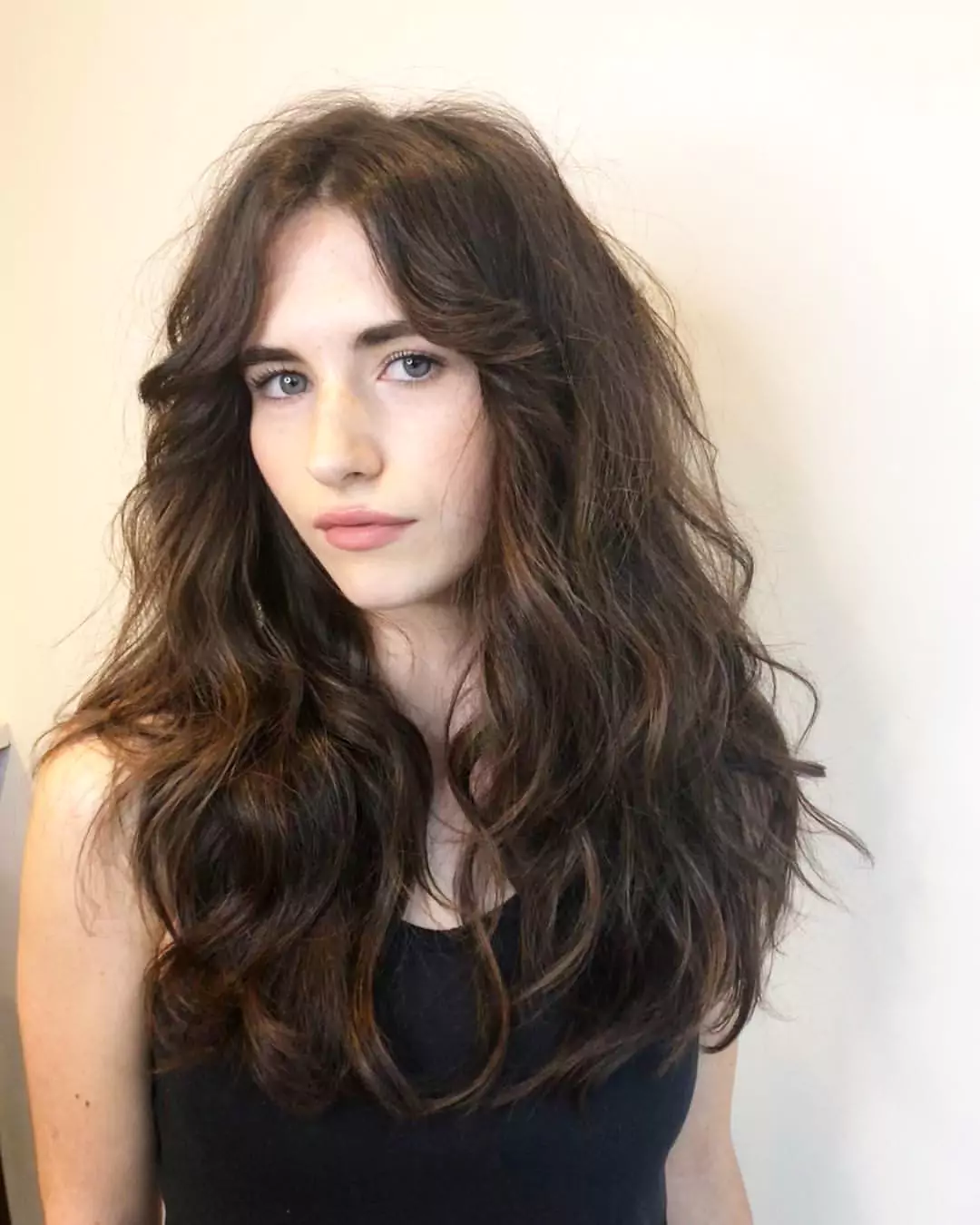 Tousled Brunette Waves with Golden Highlights