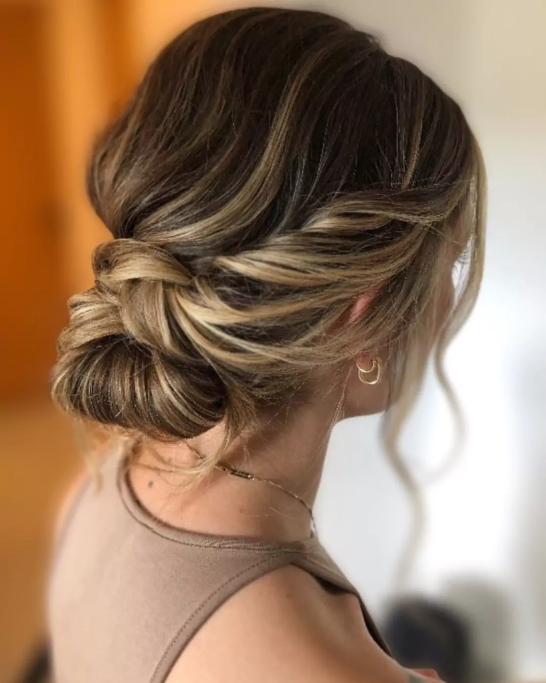 Twisted Low Bun with Face-Framing Highlights